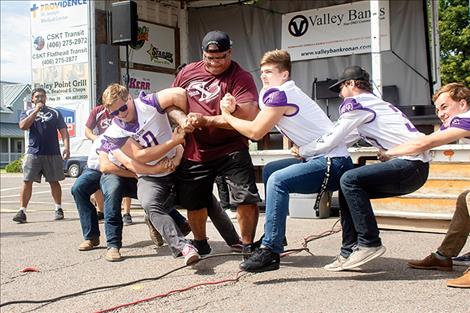 Polson Pirate Football team members and Team Xtreme use their strength to entertain the crowd.