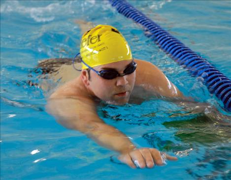 A lap swimmer reaches for the wall in the newly opened Mission Valley Aquatic Center pool. Two lanes are always open for lap swimmers, even during lessons. 