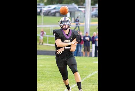 Pirate senior quarterback Bo Kelley unloads the ball to a Polson receiver.