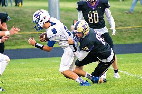 Pirate Brian Lyles drags down the Wildcat quarterback.