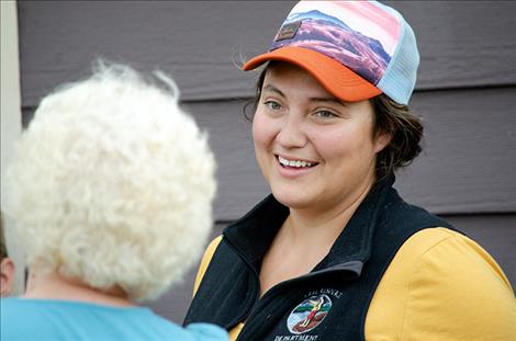 Bryce Andrews with People and Carnivores demonstrates how to use bear spray. Right: CSKT wildlife biologist Kari Eneas talks to people about bears during an informative gathering in Ronan.