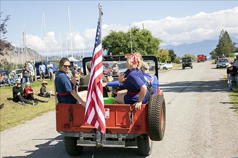 Participants in the Dayton Daze parade ride and display the flag.