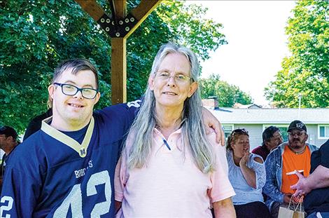 David McCullough thanks Diane Harrison for her years of service at Mission Mountain Enterprises during a celebration on Thursday. 