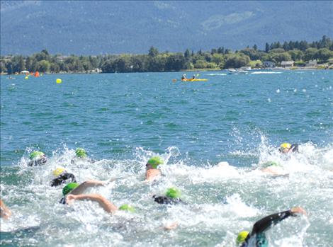 Water Daze swimmers churn up waves in Polson Bay Saturday afternoon. Nearly 80 people swam the mile-long course from the KwaTaqNuk Resort to Boettcher Park, with the fastest swim clocking in at 23 minutes, 27 seconds.