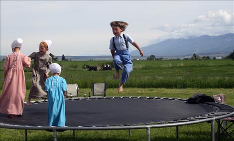 Children bounce happily on a trampoline during the first-annual Horse Progress Days.