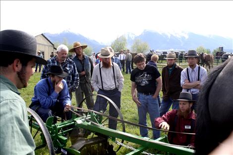 Pioneer Equipment Inc. demonstrators answer questions regarding many of their farm implements