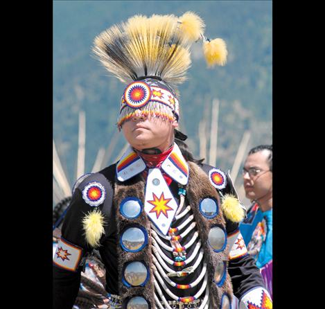 A dancer from a previous Arlee Celebration stands in full regalia.