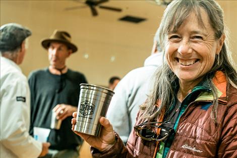 The Ronan Cooperative Brewery holds a homebrew tasting event with merchandise available on Friday.  Right: Brandon Hungerford, board president, fills up glasses at the event.