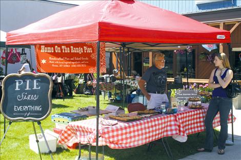 Ronan Farmers Market patron Sidnee Young talks all things pie with Home On The Range Pies co-owner Rusty Carl.