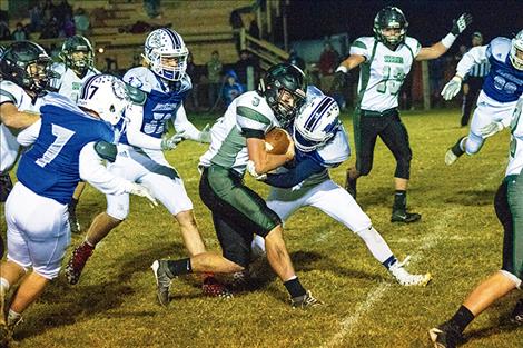 Mission Bulldog defensive back Darwin Adams wraps up a Titan runner.