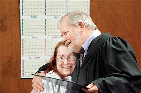 Dalke gets a congratulatory hug from Judge Manley. 