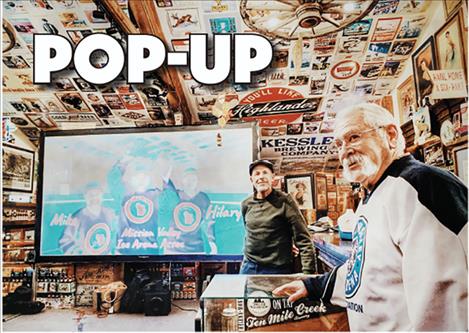 Jim Ereaux of PUFF gives the stage to Steve Lozar (right), owner of the Polson Beer Museum, to talk to festival guests about the Mission Valley Ice Arena project. 