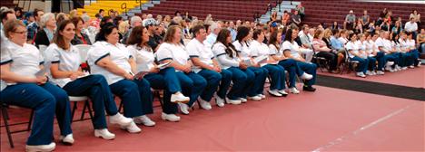 The 2013 Salish Kootenai College nursing school graduates listen as commencement speaker Patricia Kelly tells them about growth in their nursing careers.