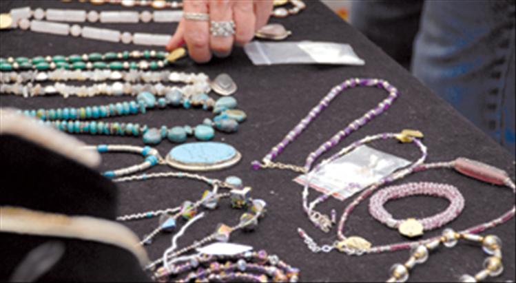 Jewelry by watercolorist Joanne Simpson is displayed at the art festival.