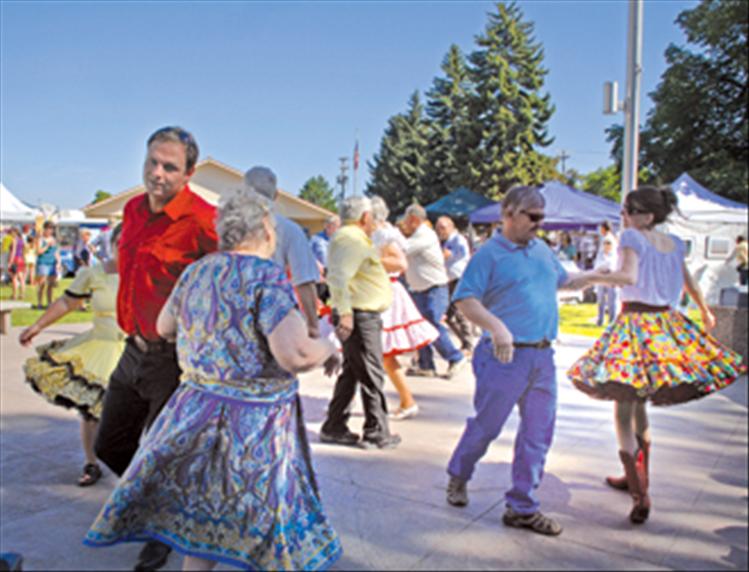 The Polson Paddle Wheelers square dance group do-si-do and swing their partners as they perform in front of the Lake County Courthouse during the Sandpiper Lake County Art Festival on Aug. 11.