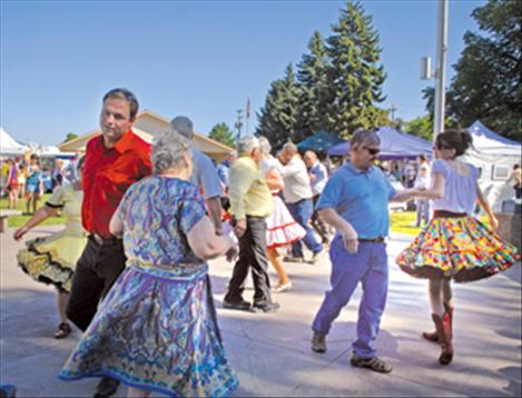 The Polson Paddle Wheelers square dance group do-si-do and swing their partners as they perform in front of the Lake County Courthouse during the Sandpiper Lake County Art Festival on Aug. 11. 