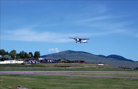 Pilot Nels Jensen takes off from Polson Airport with three boys. Saturday was windy and made flying a little choppy, but the Young Eagles loved it.