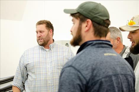 Sam Belanger, Green Ridge Biosolutions chief operations officer, (left) talks to farmers about hemp production.