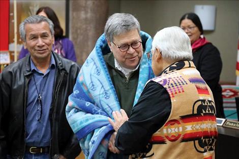 Barr was gifted a blanket before an honor song was sung. From left, Vernon Finley, director of the Kootenai Culture Committee, US Attorney General William Barr and Tony Incashola, director of the Selis Qlispe Culture Committee