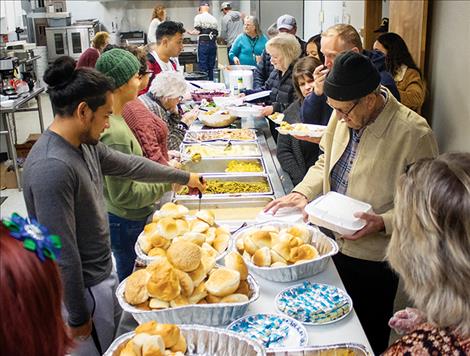 Thanksgiving Day guests line up for a free traditional  meal of turkey and all the fixings.