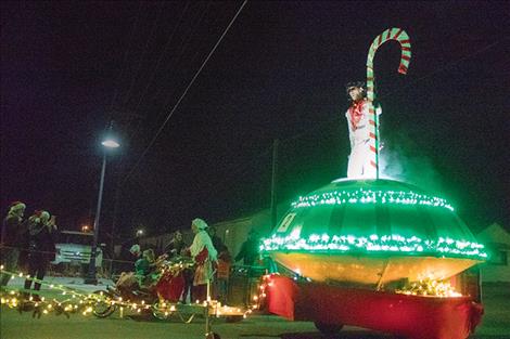 Elvis is alive as he rolls along the route atop a flying saucer, a winning entry for the Polson Running club.