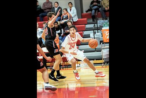 Arlee Warrior David Haynes slips past a Chief defender, above.