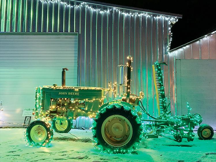 All lit up: A tractor provides a medium for sparkling lights at the "Lights Under the Big Sky" event in Ronan.