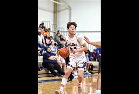 Bulldog Jedi Christy takes the ball against Thompson Falls scoring a game-high 24 points .