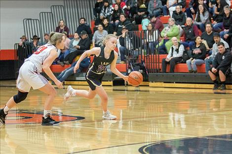 Lady Pirate Anna Cogar races down court with the ball.