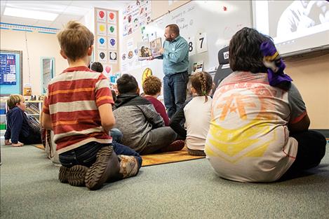 Volunteer Allison Grant reads a story about Dr. Martin Luther King Jr. to a second-grade class at Linderman Elementary.