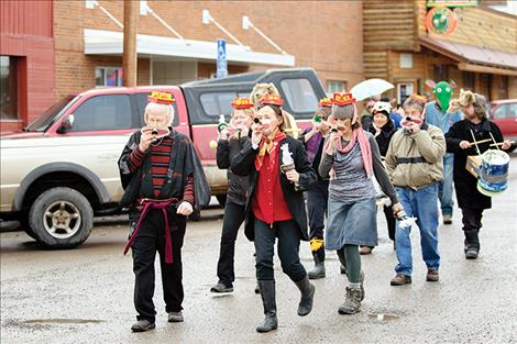 Parade participants above marched to their own tunes they played on kazoos while others wore costumes to celebrate their favorite animals, including a rooster 