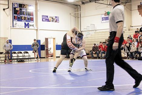 Mission and Ronan wrestlers battle in quad action on Thursday.