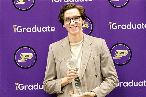 Polson High School senior Joseph McDonald holds his first-place state trophy for his work on an essay about equality in America.