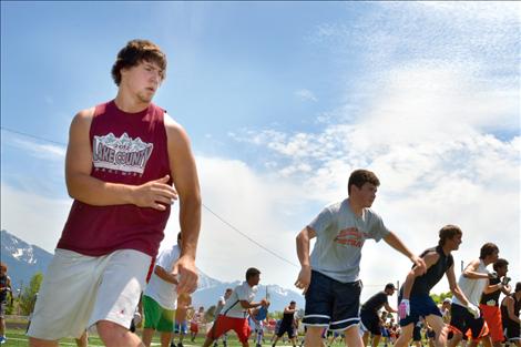 Football players practice their quickness and agility in drills run by University of Montana football players during Ronan’s football camp.