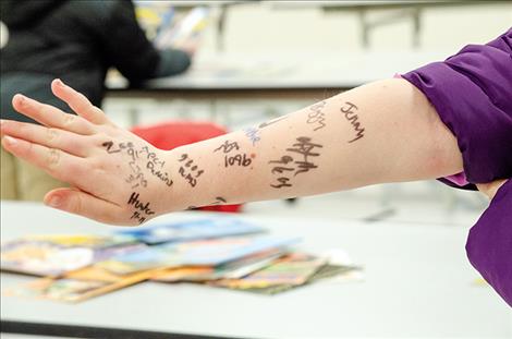  above: students collect autographs from officers. 