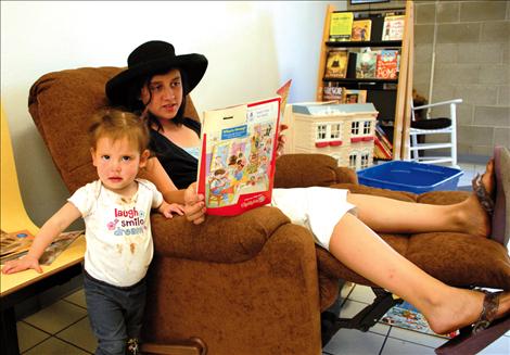 Olive Street has a hard time listening as Bianca Torres reads to her from literature at one of North Lake County Public Library’s reading nooks.