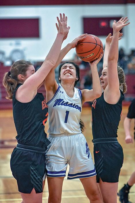 Mission Lady Bulldog Karolyna Buck battles defenders for a shot.