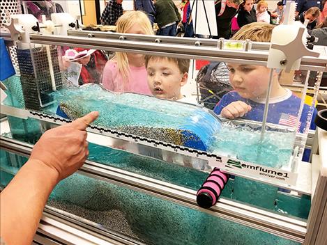 Curious kids learn about water erosion.