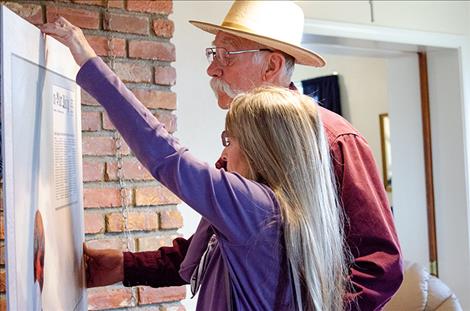 Doug and Cathy Hammill look at a photo of Scoobie during the open house. The recovery home was named after the child. 