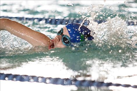 Lake Monster swim team member Truman Sawyer swims to the finish line in the 100-yard freestyle.