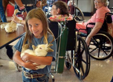 Megan Evelo brings her bunny, "Prince," to St. Luke Extended Care Facility.