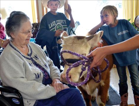 JoAnn Kraft visits with "Belinda," a year-old, bottle-fed heifer.