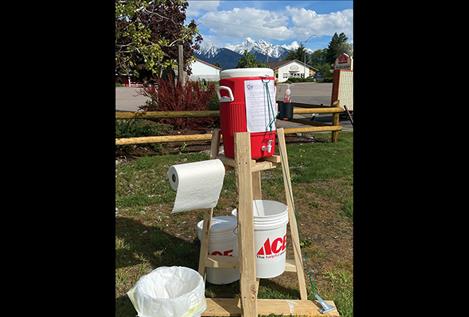 Market manager Katie Neskey demonstrated the hand washing  station. 