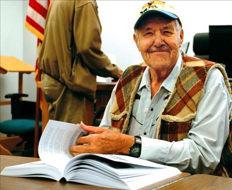 Charlo resident Harold Kent pages through volume two of Lake County School History. Kent, 91, started school in the North Moiese schoolhouse. 