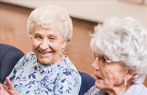 Jenny Jarvis, left, and Joedy Foster of My Glacier Village have a conversation after their walk together around the Gateway Community Center in Kalispell on March 3, 2020