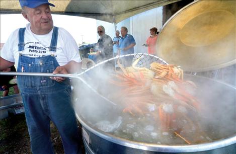 Volunteer crab cooker Jack Fay dishes up the delicacies from a boiling vat of water.