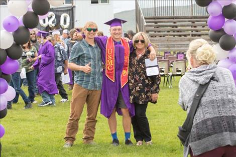 Nicholas  Daugherty shares a hug  and photo with family members.