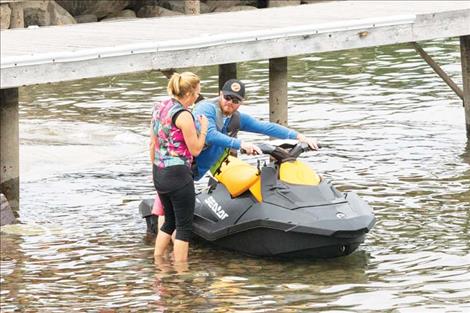 A jet skier prepares for a day at the lake.  