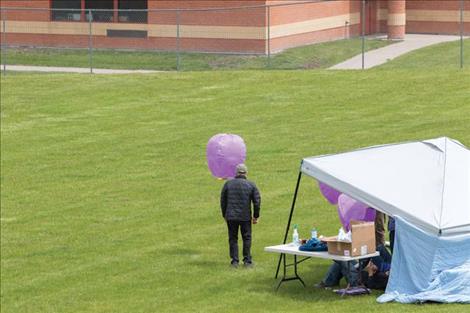 Lanterns fly upward to honor students. 