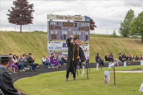  PHS grad Davis Smith waves to his  fellow classmates. 